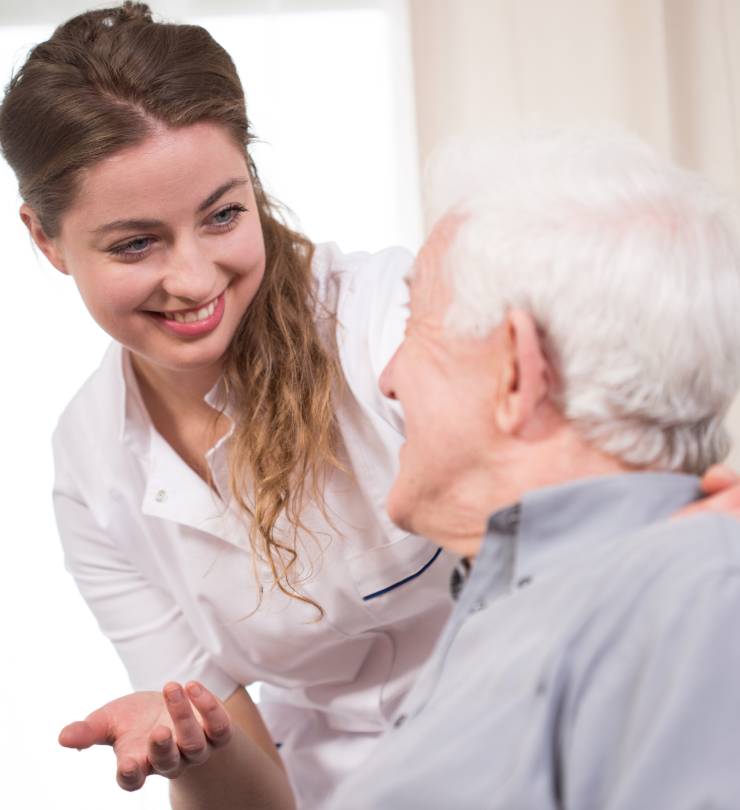 Young nurse taking care of an elder pensioner